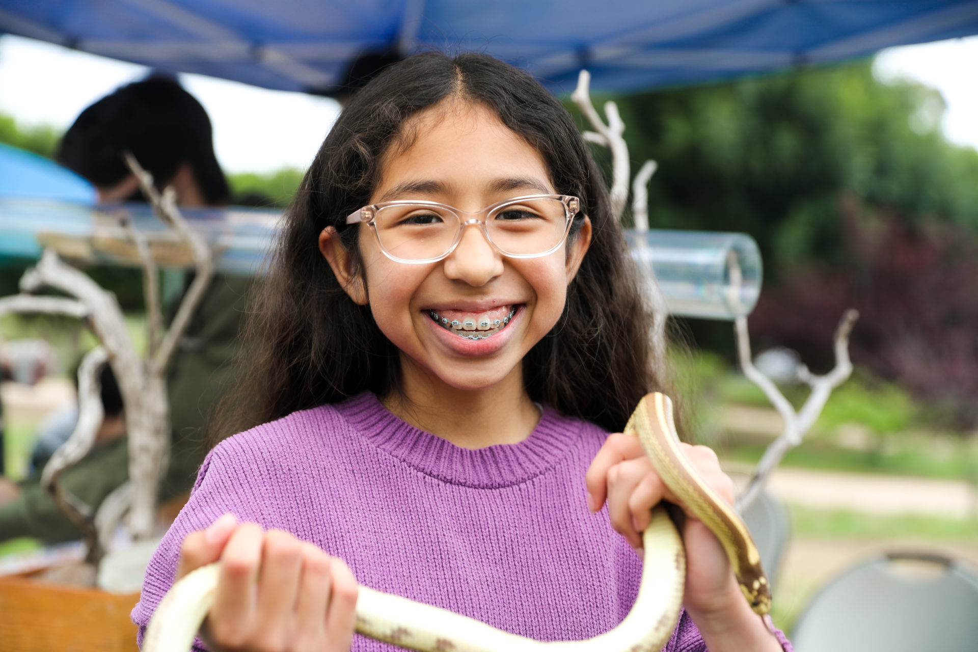 5th Grade Student Holding a Snake and Smiling